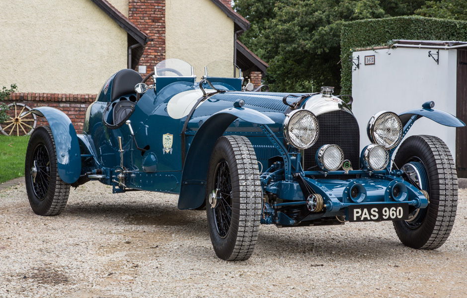 A Racing Green car on a European rally road